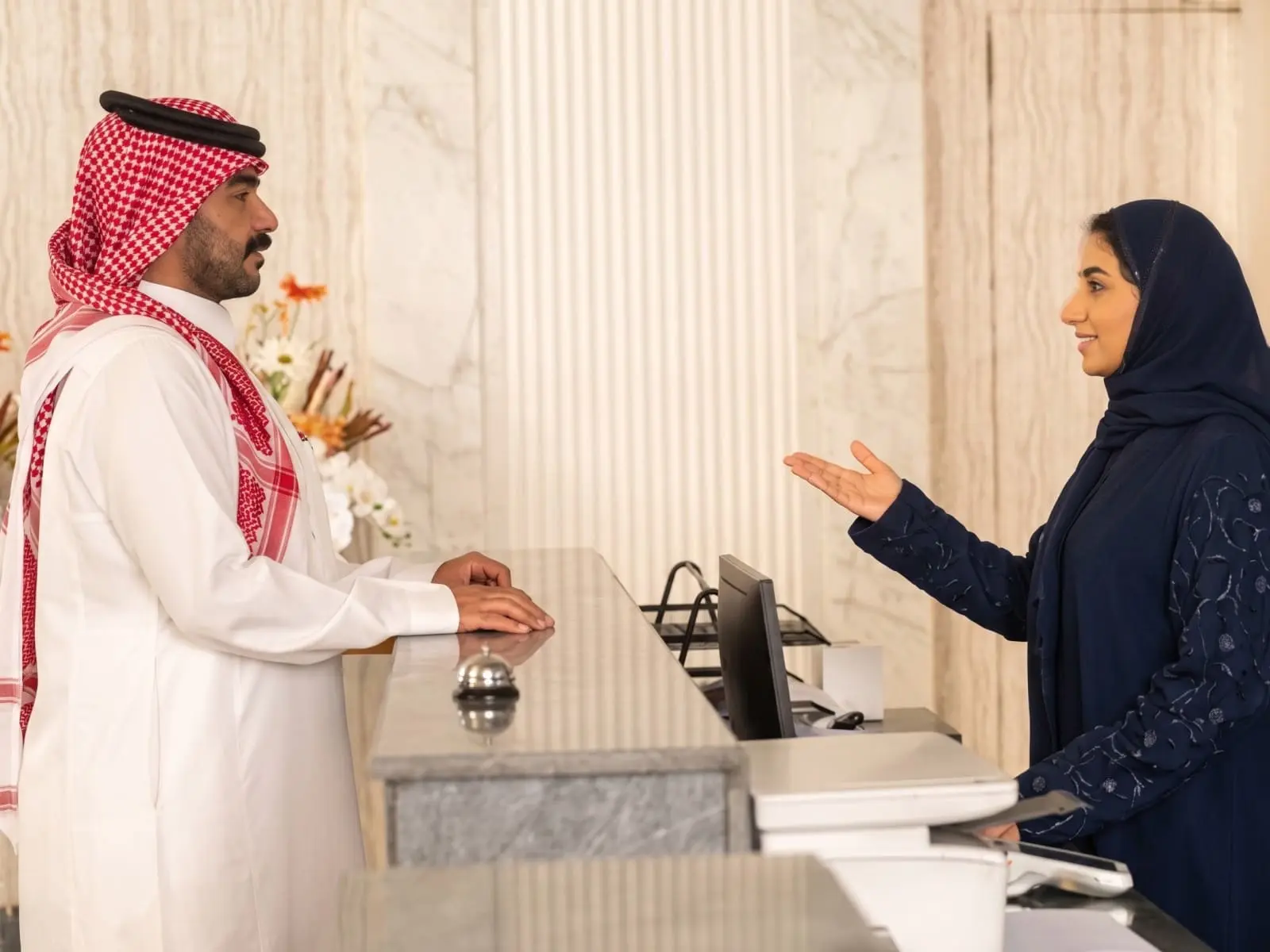 A guest checking in at a reception front desk